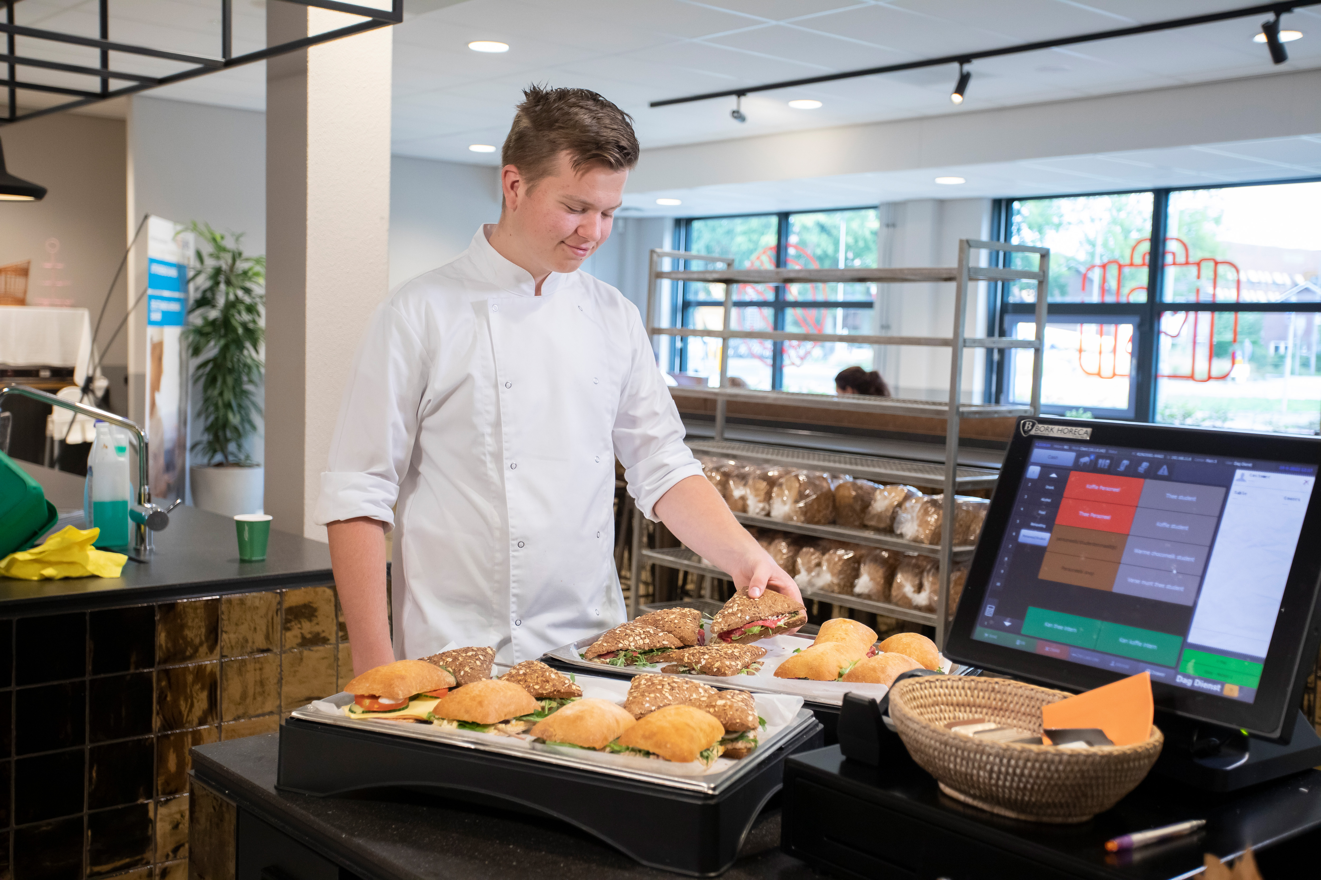 Jongen legt luxe broodjes op een schaal