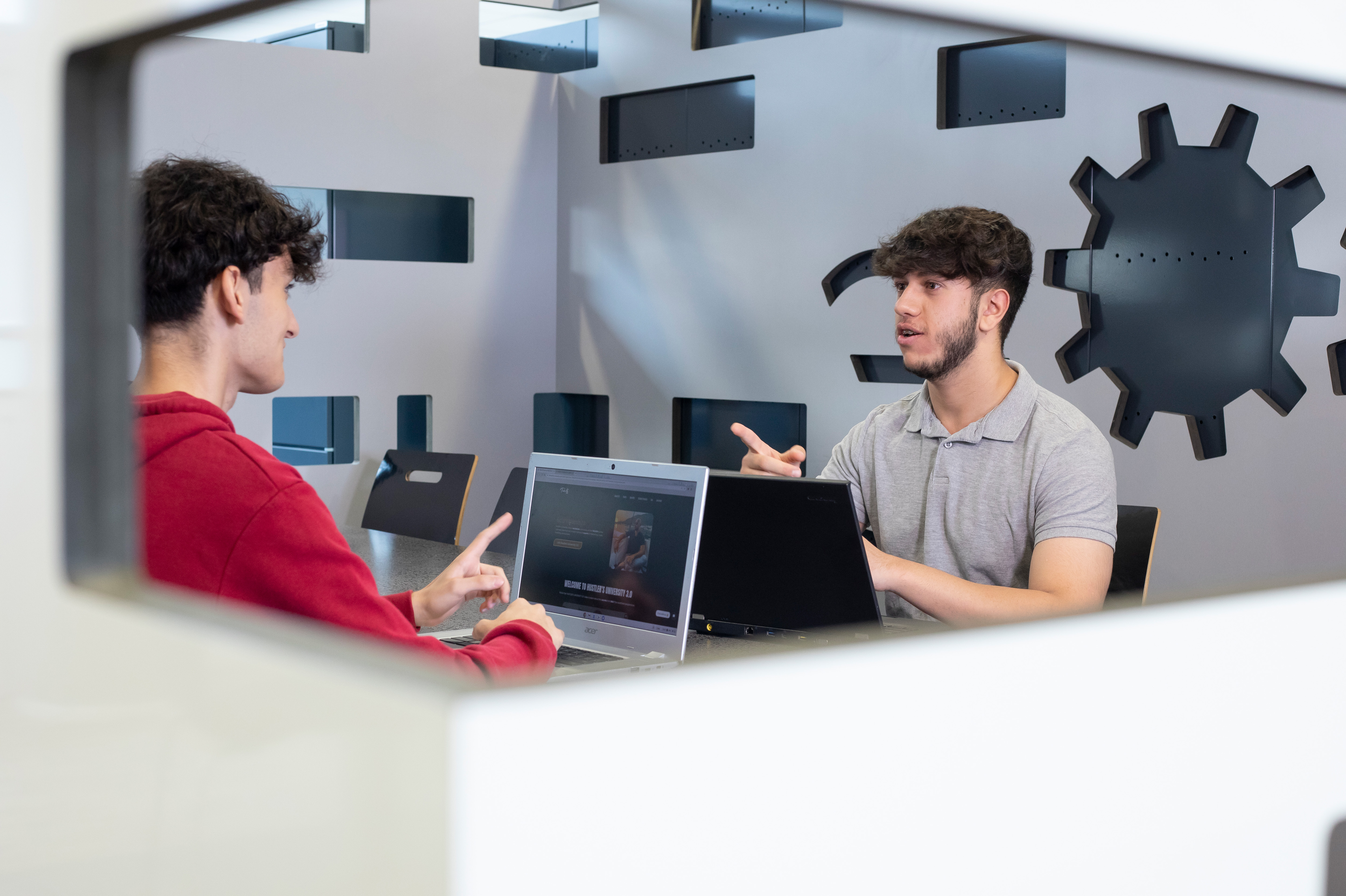 Twee jongens werkend achter een laptop